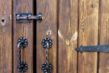 Metal Bolt And Handles On A Wooden Door Close Up