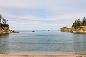 Wall Mural - Sailboat sails off the rugged coast of Oregon