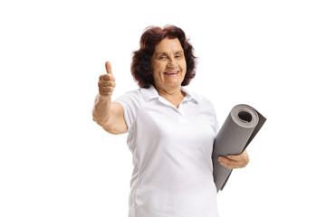 Wall Mural - Elderly woman with an exercise mat showing thumbs up