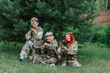 Children playing in lasertag shooting game, boy with a gun, war simulation.