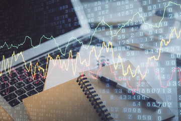 Double exposure of financial chart drawing and desktop with coffee and items on table background. Concept of forex market trading