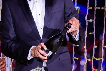 Indian married couple's hands holding champagne glasses