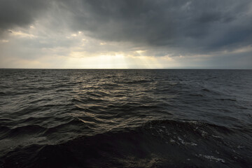 Wall Mural - North sea after a thunderstorm, Norway. Dramatic sunset sky with glowing cumulus clouds. Epic cloudscape. A view from the sailing boat. Meteorology, cyclone, climate change, seasons