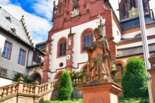 Aschaffenburg, Germany - Statue Of Theologian Adolph Franz In Front Of Historic Catholic Curch Called 'Kollegiatsstift St. Peter Und Alexander' Or 'Stiftskirche' 