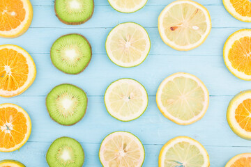 Poster - Fruit background. Colorful fresh fruit on Blue wooden board. Orange, kiwi,  lemon，Flat lay, top view,