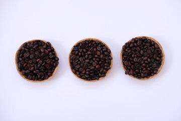 Sticker - coffee cup and coffee beans on old wood table background, space for text