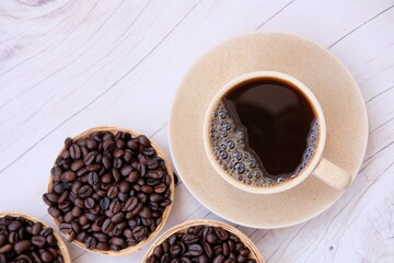 Poster - coffee cup and coffee beans on old wood table background