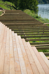 The process of building a wooden deck by the river. the river, the work of a carpenter. facilities construction.