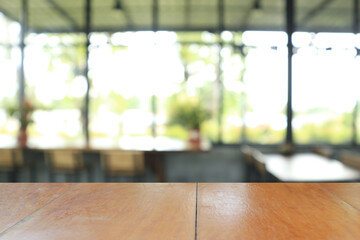 Wooden board empty table in coffee shop for background