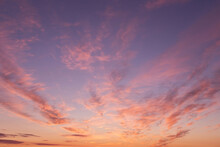 Dramatic Soft Sunrise, Sunset. Beautiful Pink Violet Orange Clouds Against Blue Sky Background Texture