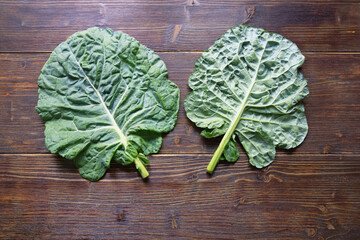 Rastan ( Collard greens, collards ) - popular leafy vegetables in Balkan cuisine. Dark rustic background, flat lay, copy space