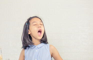 cheerful little cute girl playing and singing a song, happy kid concept