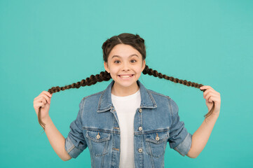 Wall Mural - Smiling teen girl with long braided hairstyle, hairdresser salon concept