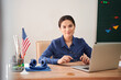 © Yakobchuk Olena - Smiling female teacher with laptop at workplace