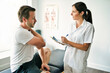 © Louis-Paul Photo - physiotherapist doing treatment with patient in bright office