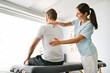 © Louis-Paul Photo - physiotherapist doing treatment with patient in bright office