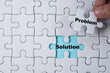 © Dilok - Hand holding and putting problem jigsaw puzzle to solution. Problem solving concept.