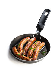 Wall Mural - Delicious pork chipolatas sausages in a frying pan isolated on white