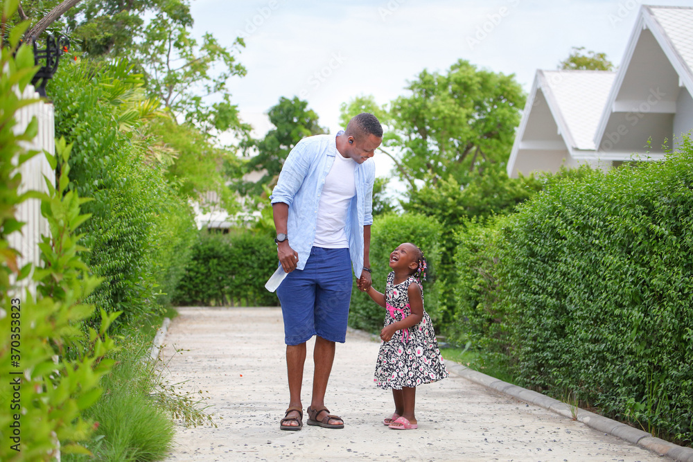 African American father is holding his little daughter hand and having ...
