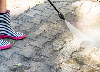 Wall Mural - cleaning the terrace with high pressure cleaner in the garden