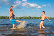 © Andrii - Family on vacation is having fun during the summer vacation. Games in the water, travel, rest, vacations.