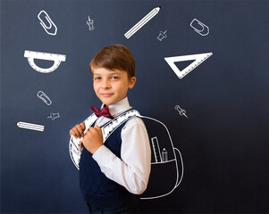 Wall Mural - Back to school. Education. Happy schoolboy with a drawn backpack and school supplies: ruler, protractor, paper clips, buttons, pencil.