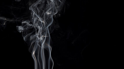 Smoke isolated on black background. Movement of white smoke