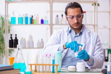 Young male chemist working in the lab