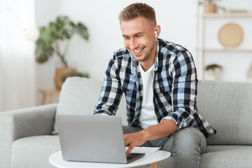 Wall Mural - Guy listening to music online in headphones