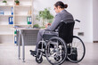 © Elnur - Young male employee in wheel-chair