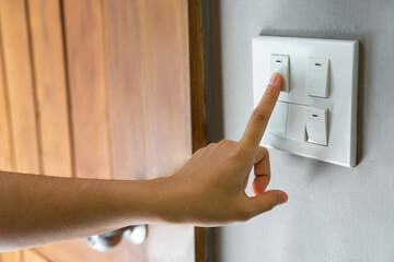 Poster - Female finger is turning off on lighting switch