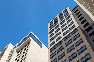 Contour silhouettes of skyscrapers against the blue sky