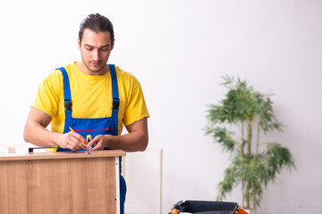 Young male carpenter working indoors