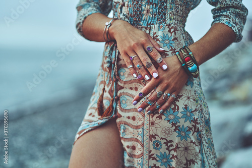 Plakat Bohemian chic gypsy woman with manicure wearing jewelry accessories and dress. Boho detail close up