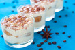 © conssuella - classic Italian dessert tiramisu in glasses, decorated with cocoa powder