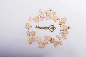 Wall Mural - Retro  style key on wooden hearts on white background