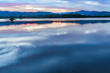 mountains of the Blue Ridge reflect in Lake Wilson after heavy rain