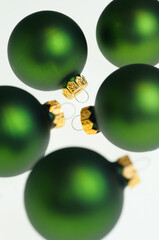 Matte green glass Christmas ball decorations on a white background