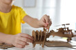 © New Africa - Little boy making carton toys at table indoors, closeup. Creative hobby