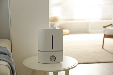 Sticker - Modern humidifier on table indoors. Space for text