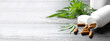 Hemp leaves and bottle with capsules on wooden table, space for text. Banner design