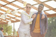 © Seventyfour - Waist up portrait of young men smiling at camera in sunlight, while posing outdoors in Summer with friends and family background, copy space
