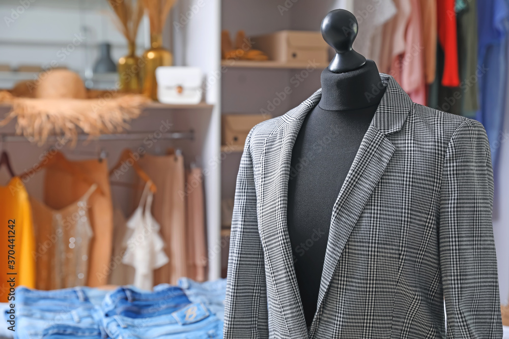 Mannequin with stylish clothes in modern store