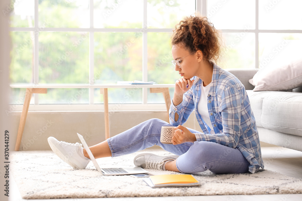 Young woman using laptop for online learning at home