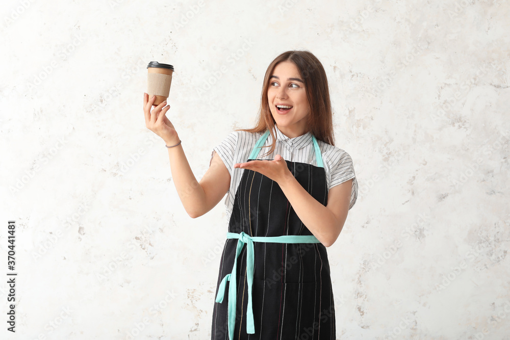 Female barista on light background