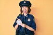 © Krakenimages.com - Young beautiful girl wearing police uniform writing traffic fine winking looking at the camera with sexy expression, cheerful and happy face.