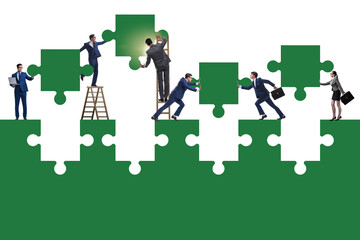 Businessman in teamwork concept with jigsaw puzzle