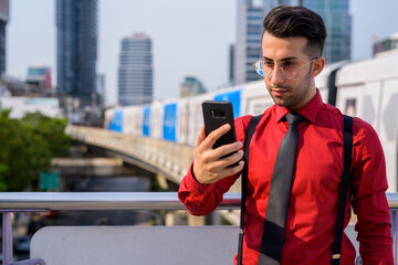 Wall Mural - Young handsome Persian businessman exploring the city