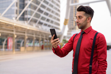 Wall Mural - Young handsome Persian businessman exploring the city