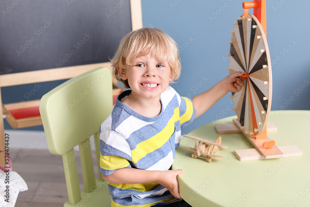 Cute little boy playing in kindergarten